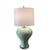 Refined handcrafted porcelain table lamps featuring a sculptural, hand-shaped body finished in a glossy fired green glaze....