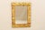 An Italian giltwood carved mirror made of 19th century fragments. This gilded rectangular Italian mirror is made of richly...