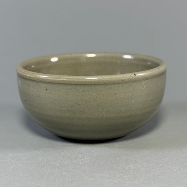 Fine antique Chinese celadon bowl. Simple rounded thick‑walled form, finished with muted celadon glaze, wonderful...