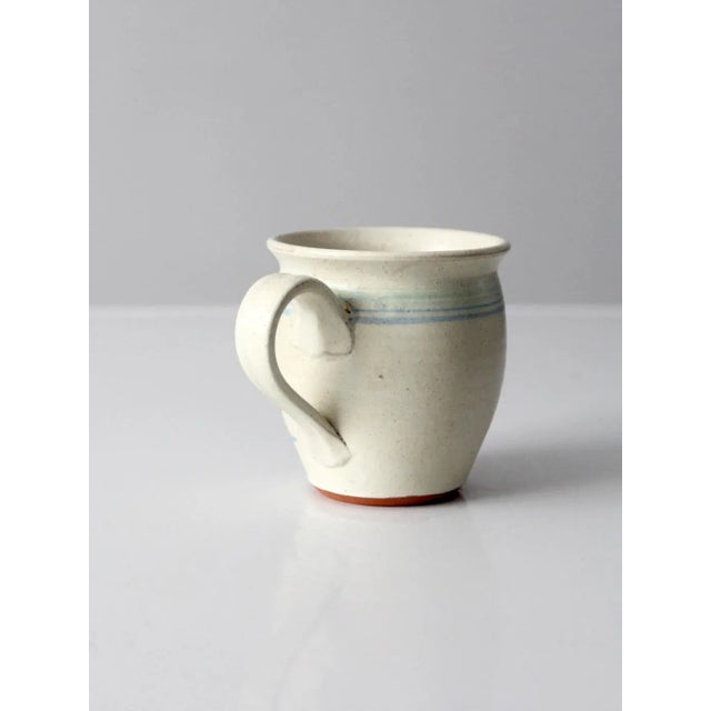A charming vintage Nova Scotia studio pottery mug, hand-crafted and signed by artist D. Kryzalka. The generously...
