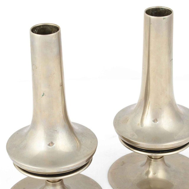 Pair of candlesticks is an original pair of decorative objects realized in the Early XX Century. Original nickel-plated...