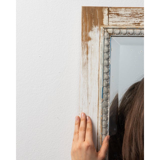 This mirror carries genuine presence, its distressed cream/white carved wood immediately setting the tone for the piece....