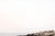 Coastal landscape artwork capturing a lighthouse overlooking a rugged shoreline with gentle ocean movement and soft,...