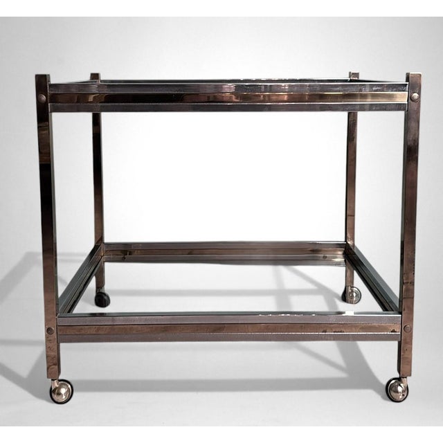 Elegant Italian bar cart from the 1960s, crafted with a refined combination of polished brass and steel—an approach...