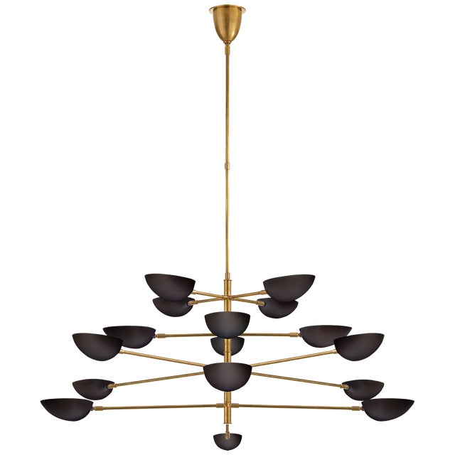 Graphic Grande Four-Tier Chandelier in Hand-Rubbed Antique Brass with Black Shades Designer: AERIN Fixture Height: 28.25"...