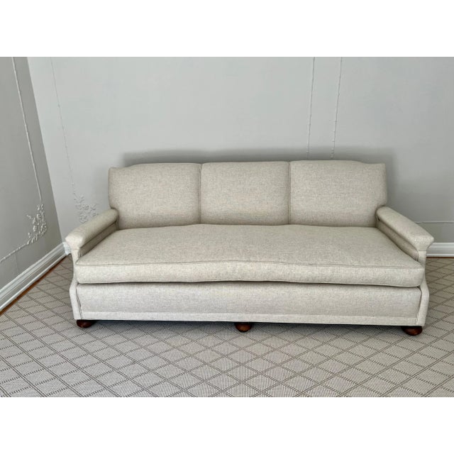 Newly upholstered sofa in neutral linen. This vintage sofa is very heavy and has hand tied springs - the new cushions are...