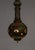 This long, narrow, hanging lamp is in the form of a narrow cylinder ending with a large ball. It mimics an Indian rose...