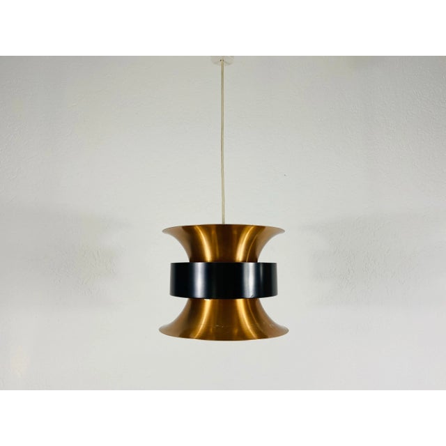 Danish black and copper pendant lamp made in Germany in the 1960s. The fixture gives a very beautiful light. It is made...