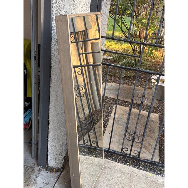 Pottery Barn full length mirror with a light wooden frame.