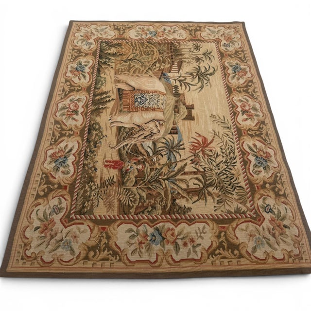 A charming handmade tapestry from China, dating to approximately 40 years ago, depicting an elephant and its caretaker...