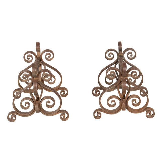 Scroll iron work with top bar to rest fire tools on their sides.