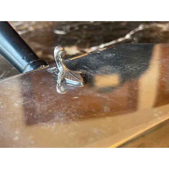 Silver-Plate Crumb Catcher with acrylic handle brush that fits slightly in the piece. Small leaf motif with black holder.