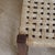A square stool with a woven natural fiber seat, originating from the European Functionalist movement and dating from...