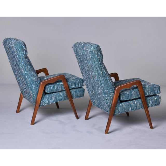 Found in Italy, this pair of circa late 1950s/early 1960s arm chairs have sleek, tapered dark stained wood arms and legs....
