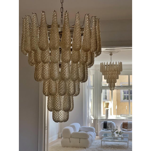 Pair of Large Elegant Eclectic Murano Chandeliers with Drop Formed Glass Prisms in a honey / amber toned color....
