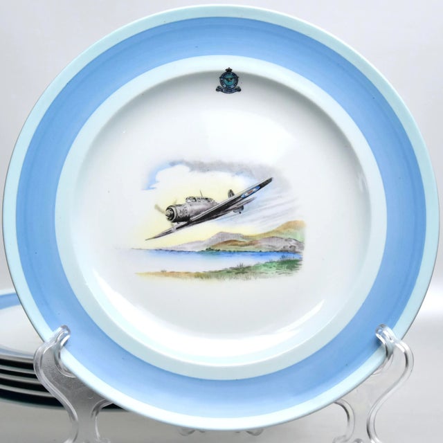 A vintage set of six decorative plates with central motif depicting the world war II era spitfire fighter jet. Having a...