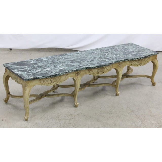A refined Louis XV style low table or bench featuring a beautifully shaped serpentine marble top above a carved apron...