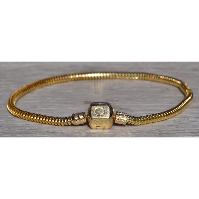 The Listowel: Ladies Vintage Chamilia Charm Bracelet in 14K Yellow Gold. Measuring 8 inches in length, this bracelet...