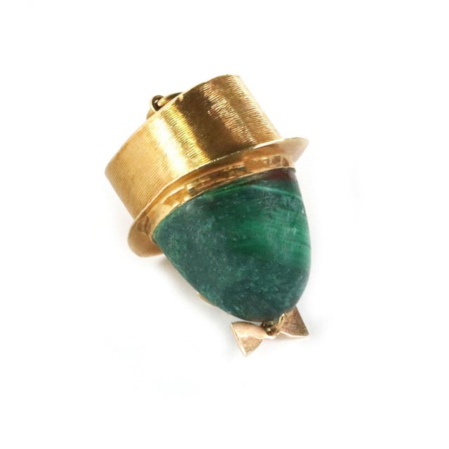 This is a charming pendant, it is crafted from 18k yellow gold. The piece features a yellow gold hat with a large oval...