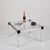 Wonderful and iconic square coffee table in brushed aluminum and black lacquered details, completed by a crystal glass...