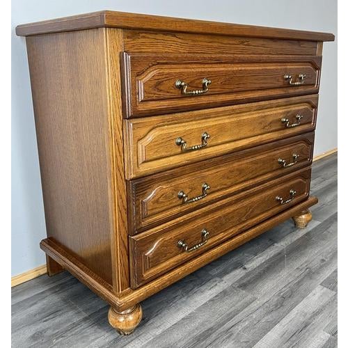 A lovely Vintage French chest of drawers featuring a classic design with four deep drawers and elegant brass handles. The...