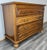 A lovely Vintage French chest of drawers featuring a classic design with four deep drawers and elegant brass handles. The...