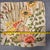 Handmade in the USA, this square pillow cover features a vibrant botanical and floral print with an artistic, eclectic...