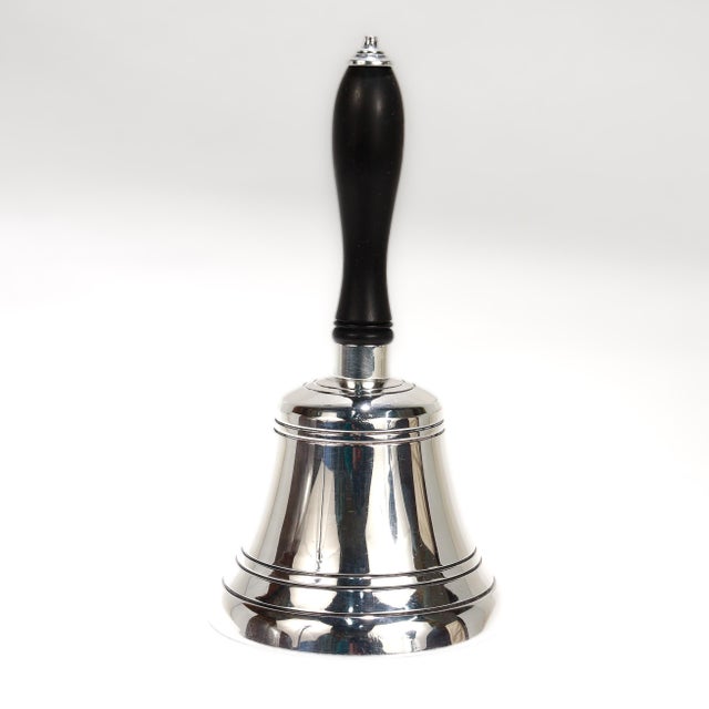 A fine vintage English silver plate table bell. In silver plate with a black wooden handle. Marked to the side of the bell...