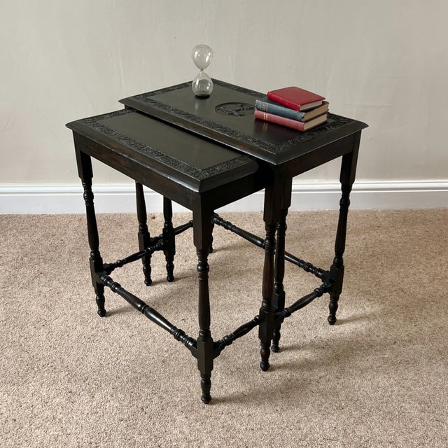 A rare and characterful pair of late victorian pair of nesting tables, circa 1880–1895. each table features a deep floral...