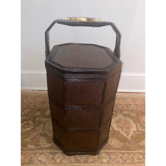 Beautiful Chinese wedding basket made of woven wicker and carved wood. Decorative brass handles. Contains 3 stacked trays...