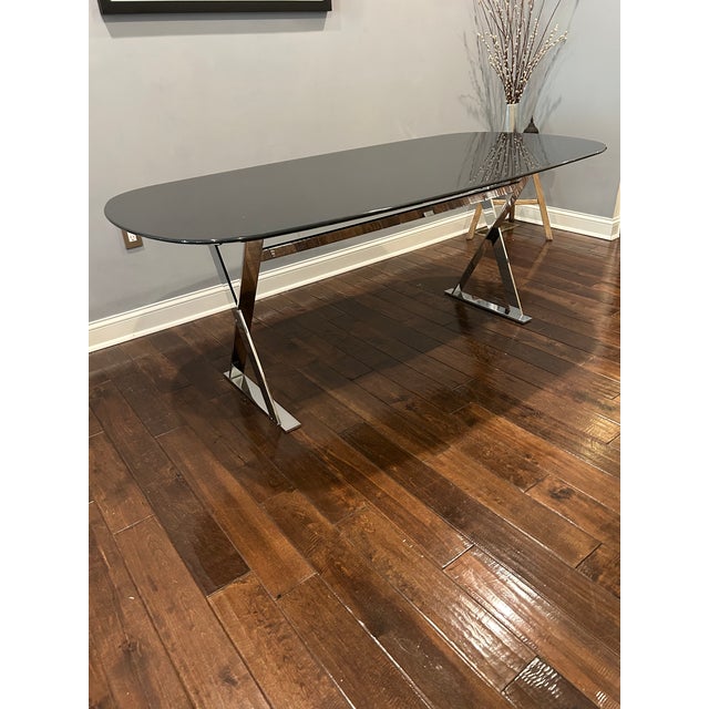 Superbly sleek Antonio Citterio Maxalto Pathos Elliptic dining table having glossy black anthracite top and X design...