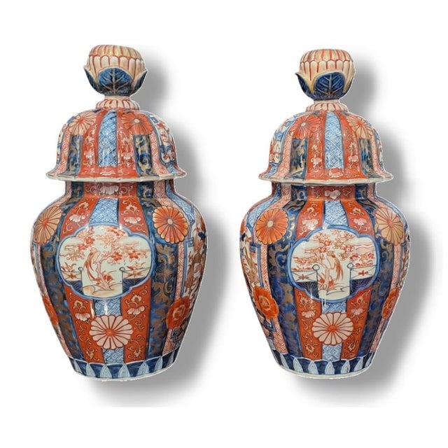 legant pair of Imari-style lidded potiches, dating back to the Meiji period (1868-1912). These vases feature the rich and...