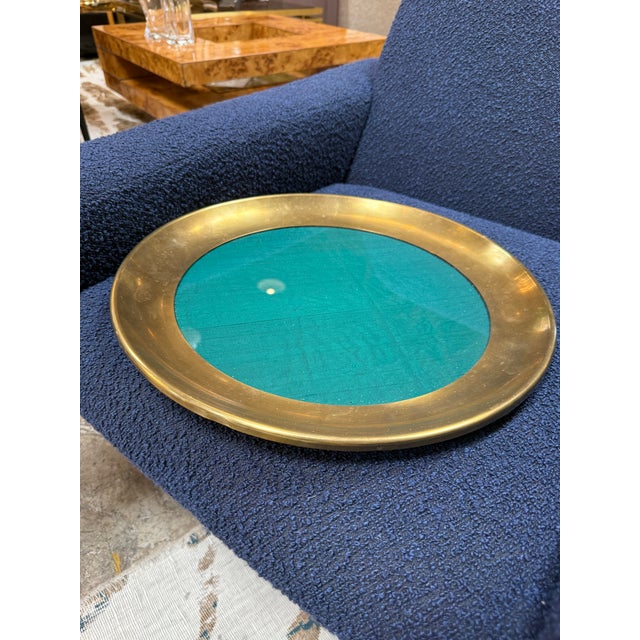 A refined Italian decorative catchall tray from the 1970s, featuring a wide satin brass rim surrounding a rich green glass...