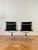 An iconic pair of ea 108 aluminium group chairs designed by charles and ray eames in 1958 and produced under license by...