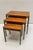 A Mid Century set of slender nesting tables attributed to Cees Braakman for Pastoe. The “floating” teak tops and sleek...