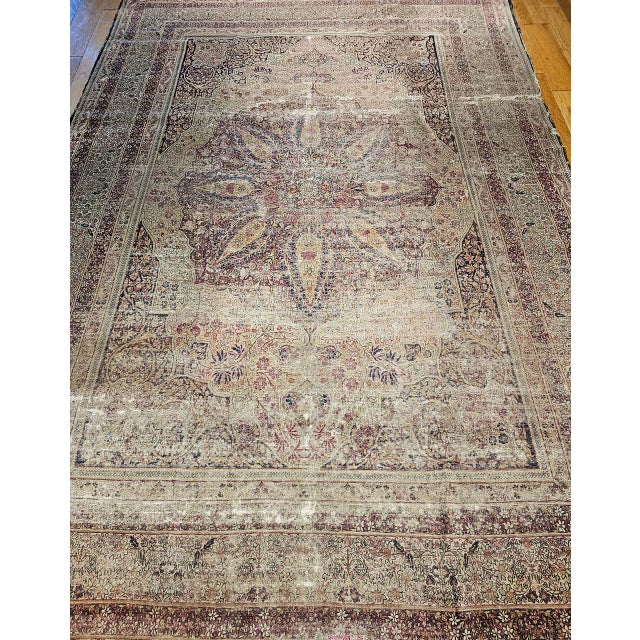 "A room size Persian Kerman Lavar hand knotted rug circa the mid to late 19th Century. The rug's primary colors are a...