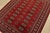 A tribal Bokhara rug hand-knotted with fine wool on a cotton foundation. This rug features rows of repeating medallions...