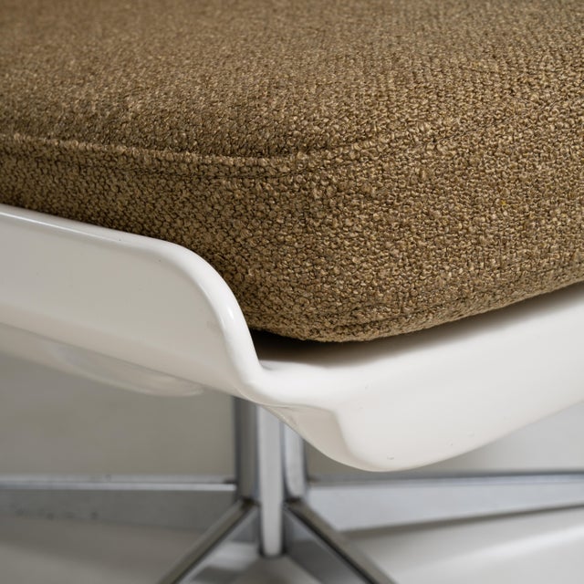 A collection of mid-century Space Age swivel chairs characterized by rounded forms and functional bases. These chairs...