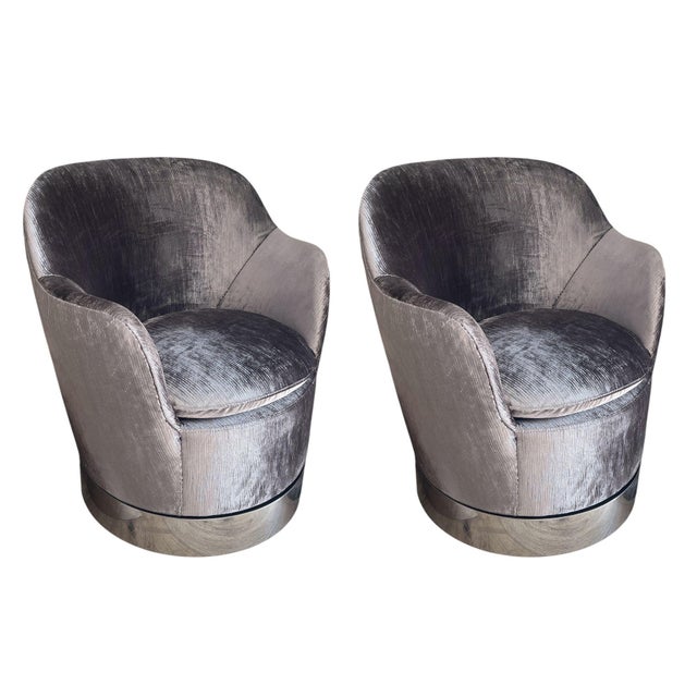 An exceptional set of four Mid-20th Century swivel barrel lounge chairs by the renowned American luxury furniture maker J....