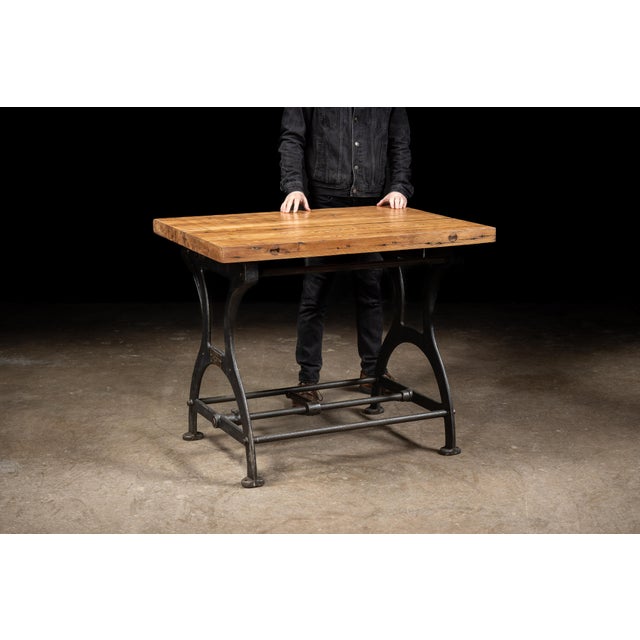 c. 1920s; C. F. Anderson & Co. - Chicago (base) Newly-manufactured oak table on an antique cast iron base. This piece was...