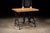 c. 1920s; C. F. Anderson & Co. - Chicago (base) Newly-manufactured oak table on an antique cast iron base. This piece was...