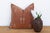 A stacked diamond-and-arrow medallion anchors the center of this handcrafted Moroccan cactus silk pillow, bordered by...