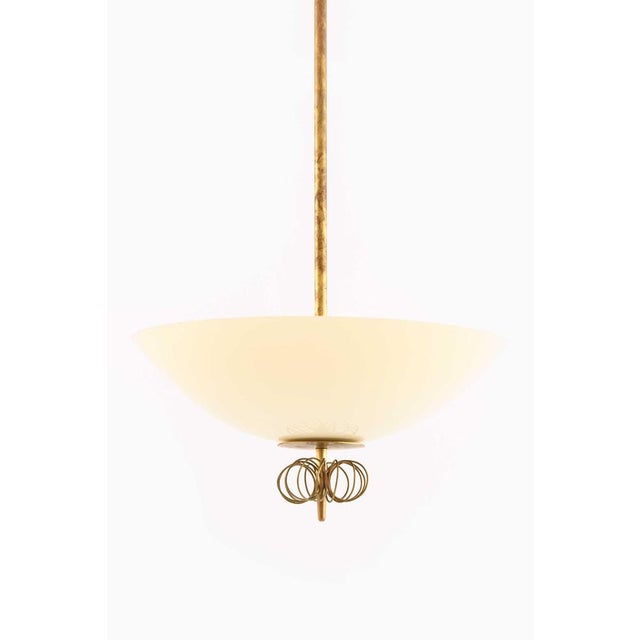 This very rare ceiling lamp, designed by Paavo Tynell and produced by Taito Oy in Finland during the 1950s, is a...