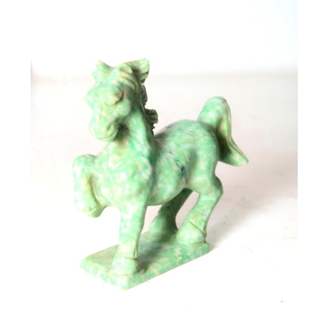 Hand-carved miniature horse on a base; all one stone. It is one of a collection of precios and semiprecious stone carvings...