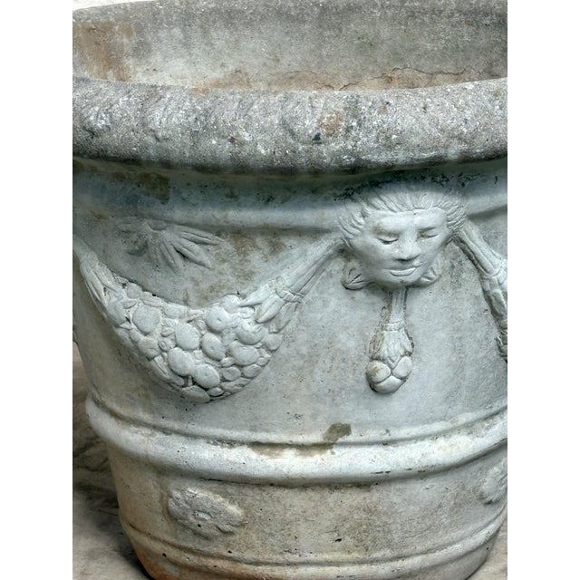 A beautifully aged pair of mid‑century cast‑stone urns, each hand‑poured and finished with the subtle individuality. The...