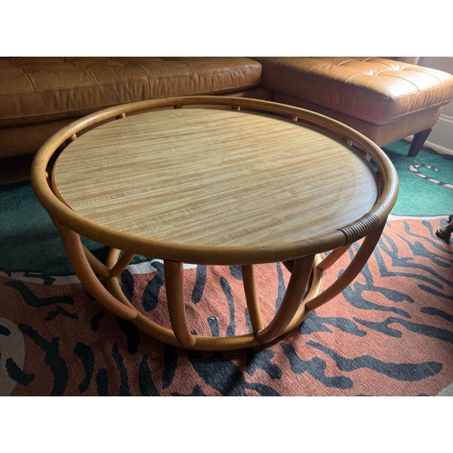 Add a touch of organic warmth and vintage charm to your living space with this stunning rattan coffee table. Its airy,...