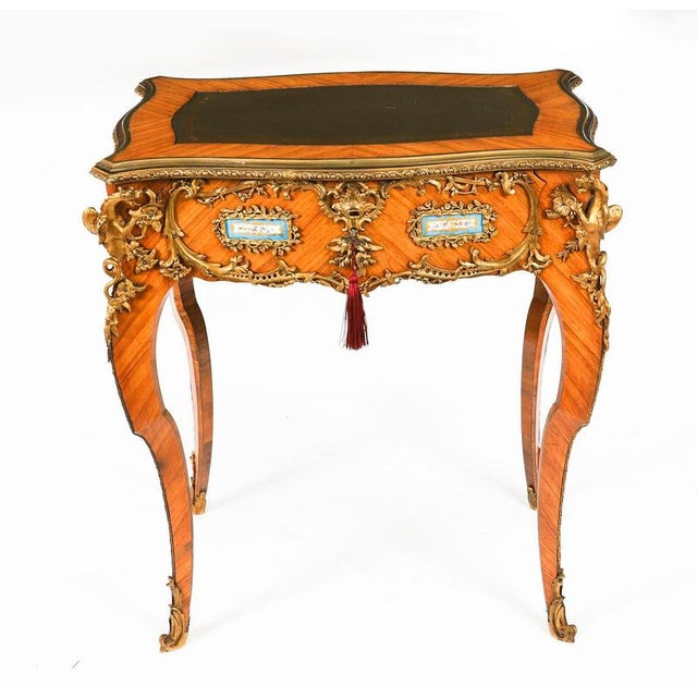 A fine antique French wood, porcelain and ormolu mounted bureau plat, in the manner of Linke, Circa 1860 in date. The...