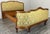 A striking Vintage French Louis style upholstered double bed frame, featuring elegant carved woodwork and decorative...