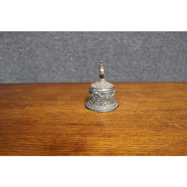 Gorham silver-plated bell featuring an ornate floral and foliate relief design around the body, a domed lid, and a...