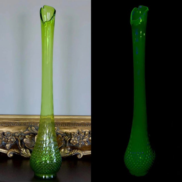Impressive 26-inch vintage Kanawha Glass swung vase crafted in rare dark uranium glass. The dramatic elongated silhouette...